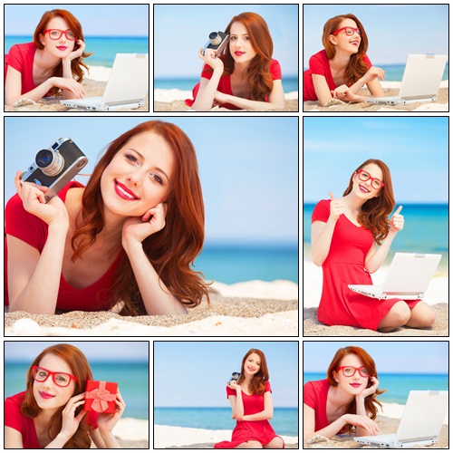 Redhead girl with camera on the beach - Stock Photo
