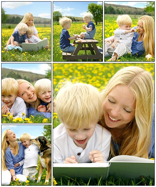 Happy Mother and Child Reading Book Outside in Meadow - Stock Photo